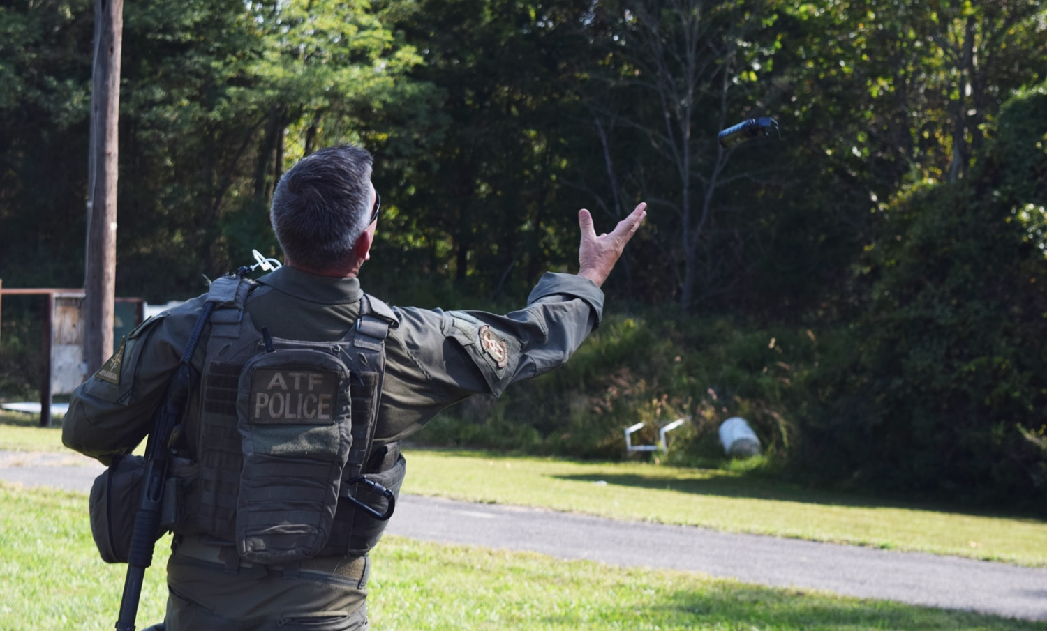 After a door breaching demonstration, an SRT agent tosses a flash bang into the air. The device is supposed to startle, confuse and disorient suspects. (Photo: Daniel Terrill/Guns.com)