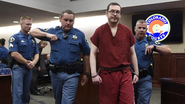 Colorado theater shooter James Holmes is led out of the courtroom after being formally sentenced in Centennial, Colo., on Aug. 26, 2015. (RJ Sangosti / The Denver Post via AP)
