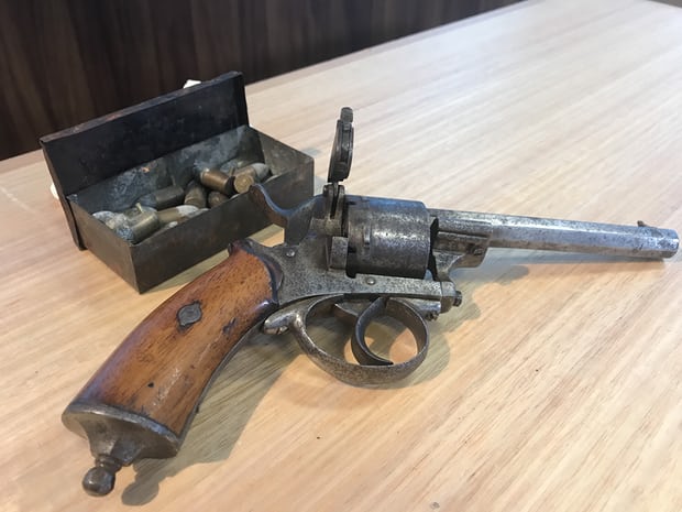 A 150-year-old antique Belgian Lefaucheux 9mm pin-fire revolver and a tin of original rounds handed into Tasmanian police. (Photo: Ethan James/AAP)