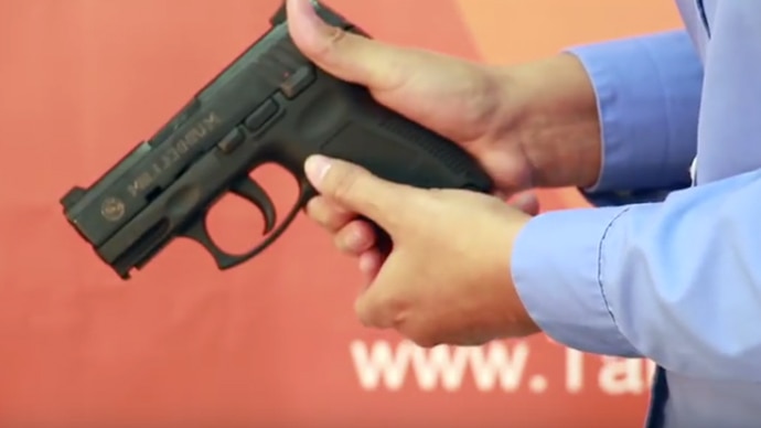 A representative showing how to safely pack a Taurus handgun before shipping it to the company. (Photo: Taurus/Youtube)
