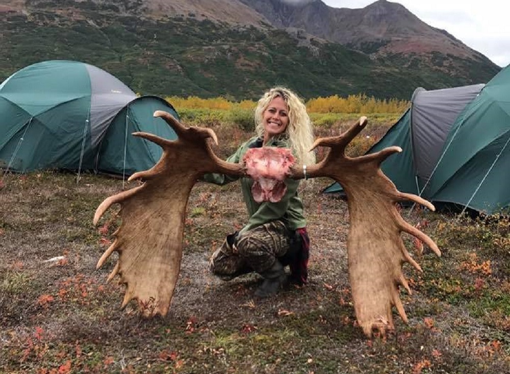 Hunting enthusiast Jessica Grays posing with massive horns taken from a moose killed by her partner. (Photo: Facebook)