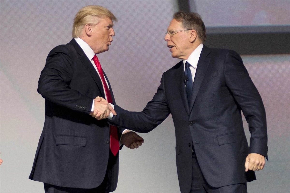 President Donald Trump and NRA president Wayne LaPierre shake hands on stage at the NRA leadership forum in April. (Photo: Getty Images)
