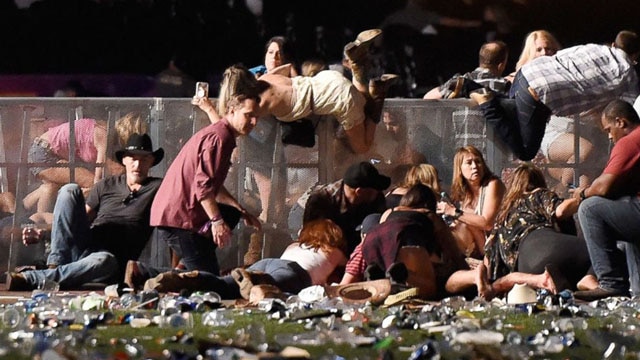 People scramble for shelter at the Route 91 Harvest country music festival, Oct. 1, 2017, in Las Vegas. (Photo: David Becker/Getty Images)