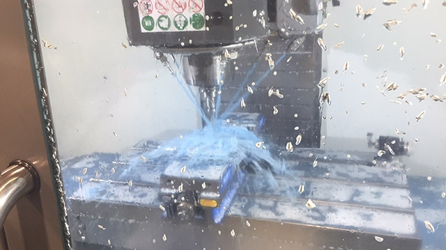 A block of 7075 aluminum becomes a finished bullpup frame in 30 minutes, thanks to laser-operating robot and some water. (Photo: Eve Flanigan)