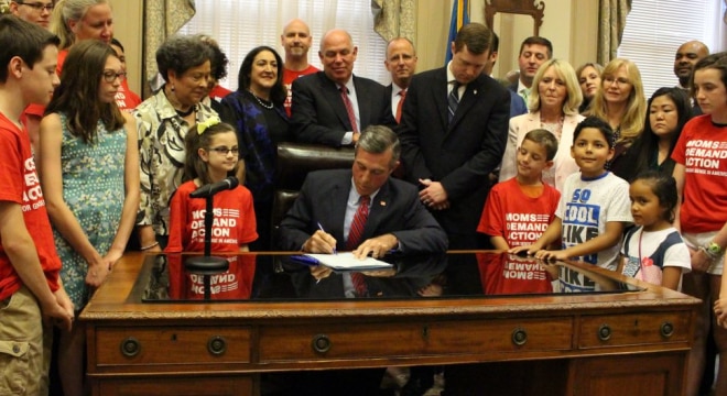 Carney signed the proposal into law this week before a crowd of gun control advocates. (Photo: Delaware Governor's office)