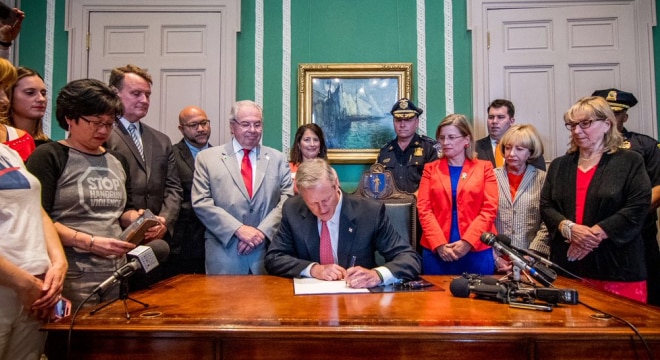 Baker signed the proposal into law this week before a crowd of lawmakers and gun control advocates. (Photo: Massachusetts Governor’s office)
