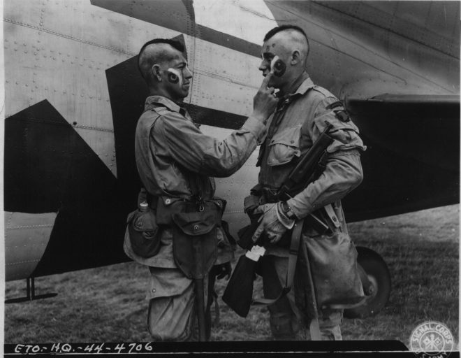 Paratrooper applies war paint National Archives 111-SC-193551