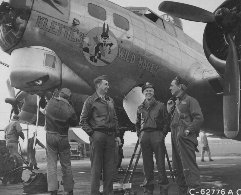 "England. The crew of the 91st Bomb Group, 8th Air Force, relax beside the Boeing B-17 Flying Fortress, Klette's Wild Hares. They have just returned from a bombing attack on enemy territory." Note the M1911 pistol and holster of the crewmember to the far right. (Photo: U.S Army Air Corps via National Archives)