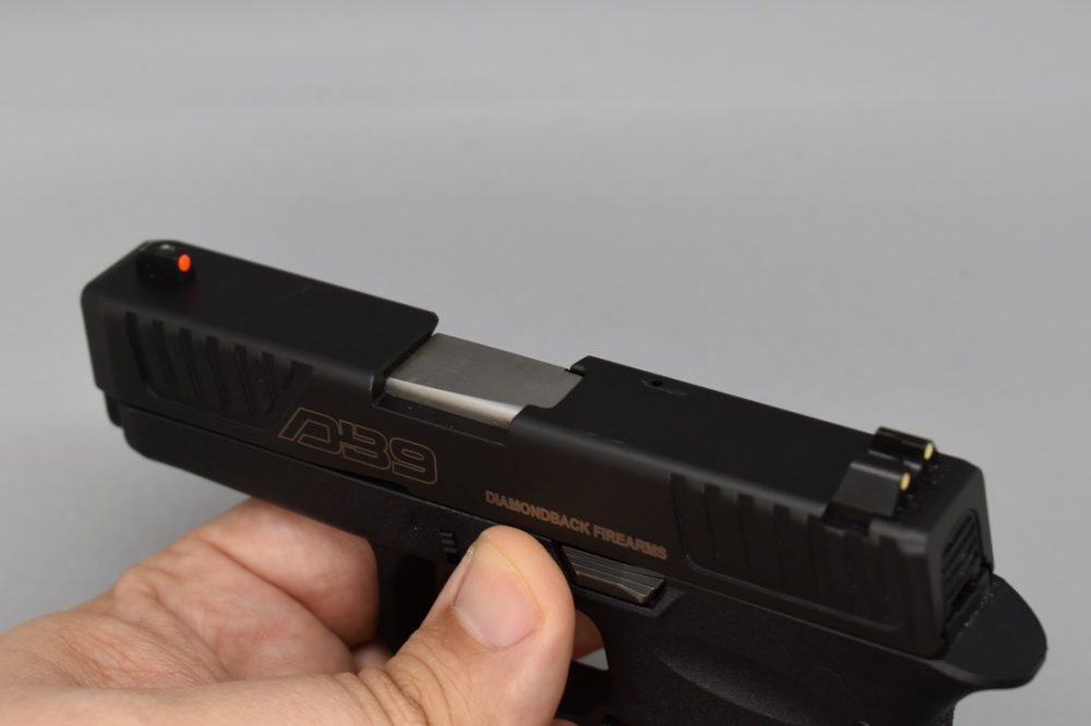 The replaceable sights include a red front post with green rear dots while night sights are readily available. Note the front and rear slide serrations and fenced slide stop lever