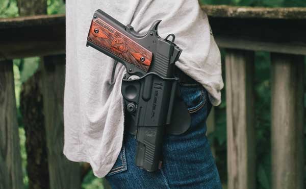 1911 sitting in holster on female wearing jeans