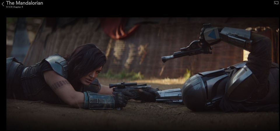 Cara and the Mandalorian draw their pistols after a brief scuffle in "Chapter 4: Sanctuary" (Photo: IMFDB)