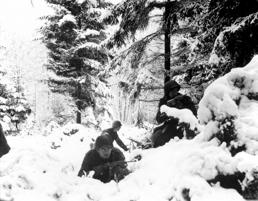 U.S. Army infantrymen of the 290th Regiment, 75th Infantry Division, fight in fresh snowfall near Amonines, Belgium during the Battle of the Bulge, Jan. 4, 1945. Note the M3 Grease Gun to the right and M1 Carbine to the left. (Photo: U.S. Army)