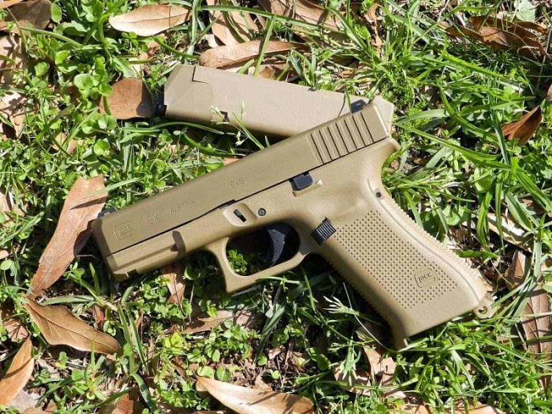 Glock G19X with magazine in a field of green grass