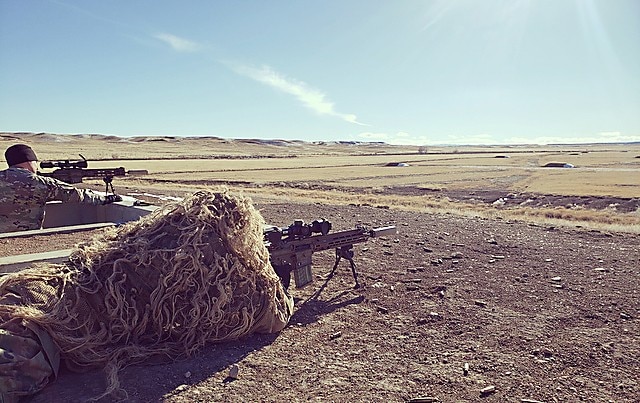 A test Sniper engages targets identified by his spotter while wearing a Ghillie suit during the Compact, Semi-Automatic Sniper Rifle (CSASS) operational test at Fort Carson, Colo. (Photo Credit: Maj. Michael P. Brabner, Test Officer, Maneuver Test Directorate, U.S. Operational Test Command)