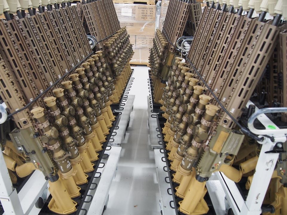 HK SDMR rifles on two racks in a factory