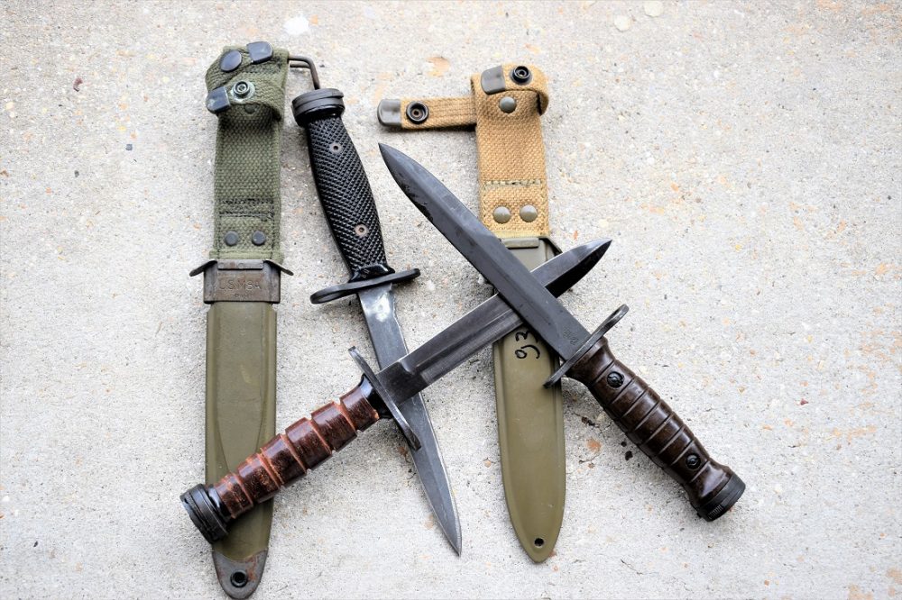 The M1 Carbine used the M4 bayonet, with a distinctive small barrel mount ring on the crossguard. Shown are U.S-, Japanese and Italian-made variants. (Photo: Chris Eger/Guns.com)