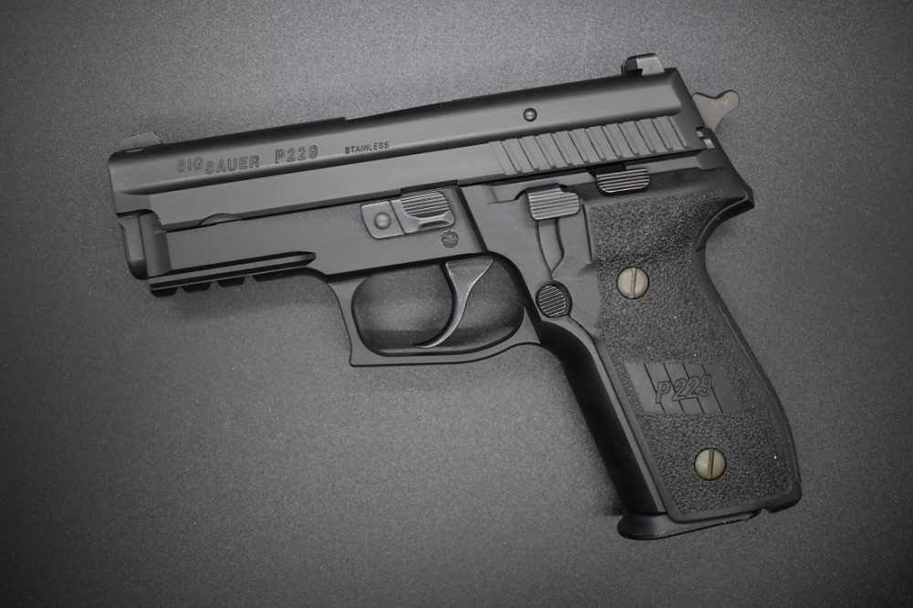 Sig P229R 9mm pistol with an SRT trigger on a black background