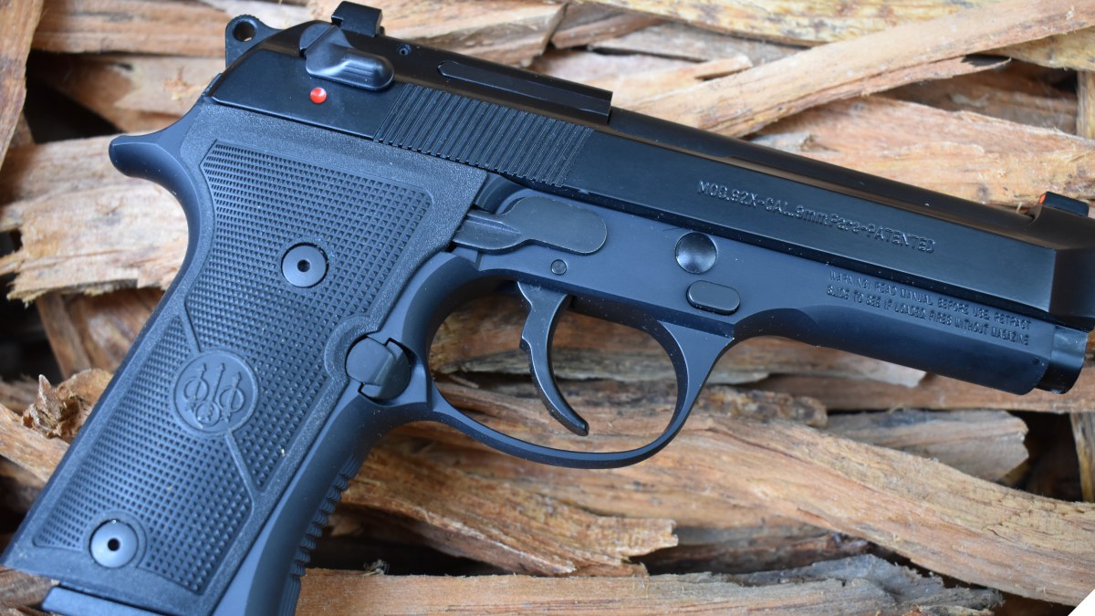 Beretta 92X 9mm pistol on a pile of tender