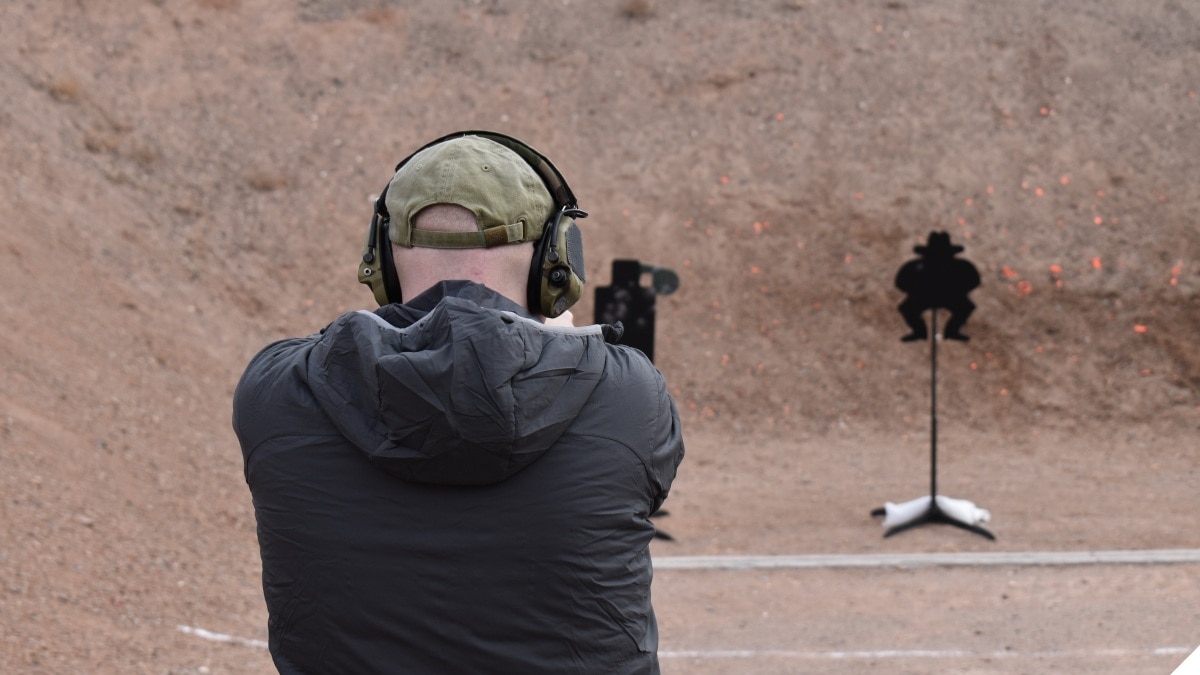A man shoots on an outdoor shooting range 