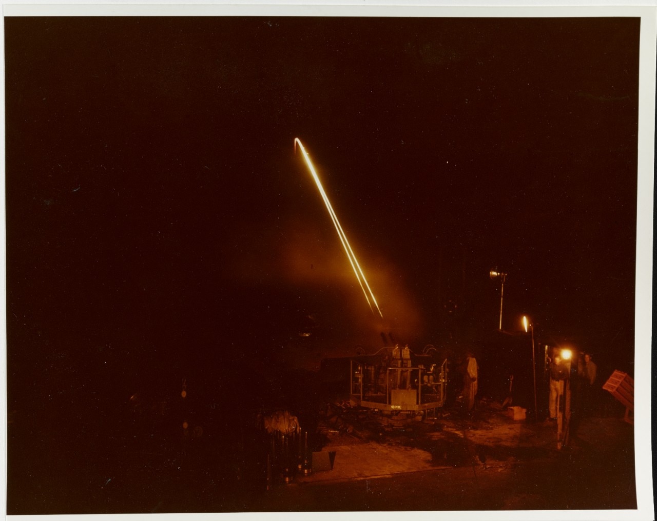80-G-K-13598 Dahlgren Tracer bullets from a twin 40mm machine gun mount arc across the sky, aimed at targets in the Potomac River,