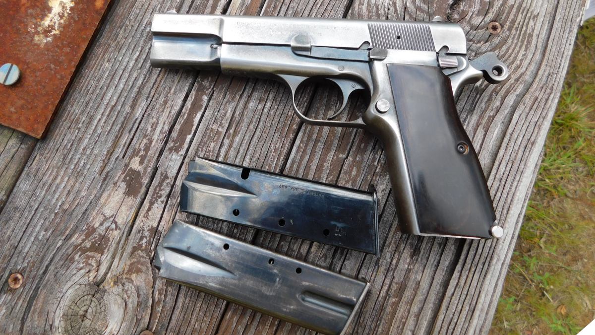 An aged Browning Hi-Power T-series on distressed wooden table