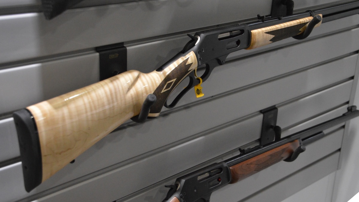 A rack of Marlin lever-action rifles on a wall display