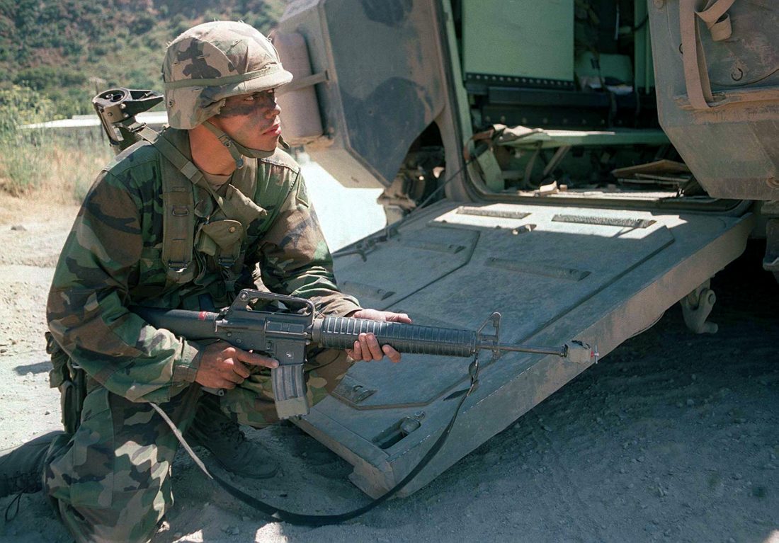 A soldier, armed with 5.56mm Colt M16A2, from the 3d Infantry Battalion, 160th Regiment, US Army National Guard, sets up a hasty defense after disembarking from a Bradley fighting vehicle during Military Operations in Urban Terrain (MOUT) operations, Exercise KERNEL BLITZ '97, June 28, 1997. (Photo & Caption: National Archives)